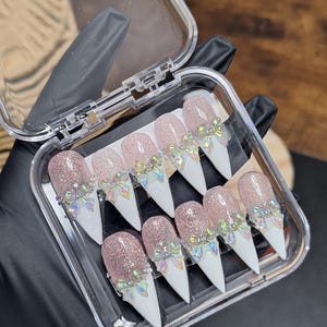 May include: A set of three ceramic mugs with a speckled, matte finish. The mugs are in shades of cream, light gray, and dark gray. Each mug has a simple, minimalist design, perfect for coffee or tea.