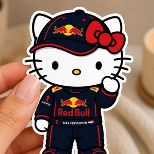 May include: A die-cut sticker featuring a white cartoon cat character wearing a dark blue Red Bull racing cap with a red bow, and a matching dark blue racing suit with the text Red Bull, Max Verstappen, and the number 1 printed on it.