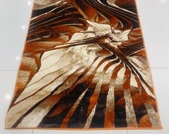 Modern Abstract Brown‑Orange Area Rug with Dynamic Striped Design
