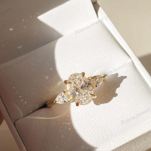 Handmade Three Stone Moissanite Ring: 14K Yellow Gold Oval Engagement Ring