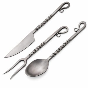 May include: Set of three handcrafted metal serving utensils: a knife, fork, and spoon. Each piece features a twisted handle design and a looped end for hanging. The knife blade is straight, and the fork has two tines.
