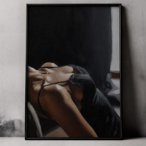 May include: A framed art print depicting a figure in a black dress, reclining with their head tilted back. The painting has a dark, atmospheric style, with an emphasis on the figure's form and the use of light and shadow.