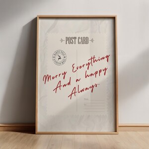 May include: Framed postcard print with a vintage aesthetic. The design features the words "Merry Everything And a happy Always" in a handwritten style, along with a "North Pole Express Mail" stamp and "Post Card" text. The frame is a light brown color.