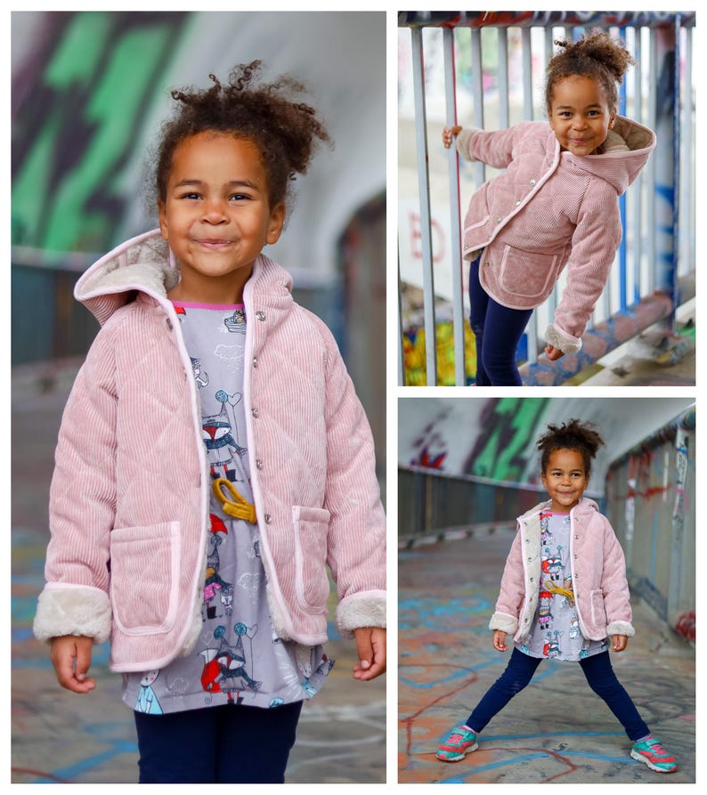 May include: A young girl wearing a pink corduroy jacket with a white fur trim and a grey and white patterned shirt. The jacket has a hood and two pockets. The girl is smiling and looking at the camera.