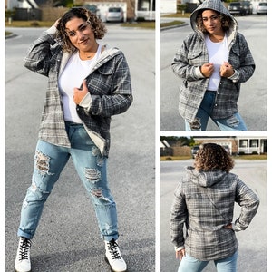 May include: A gray and white plaid flannel shirt with a fleece-lined hood. The shirt has a button-up front and long sleeves.