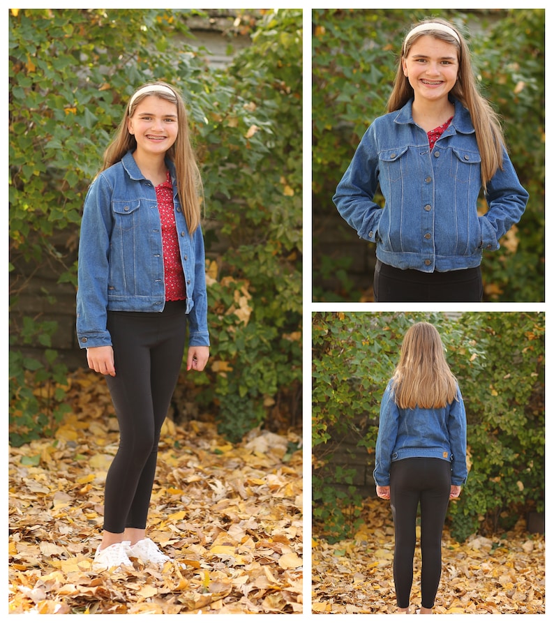 May include: A blue denim jacket with button closures, worn over a red top with white polka dots, and black leggings. The jacket has pockets and a classic collar. The outfit is completed with white sneakers. The background features autumn leaves and greenery.