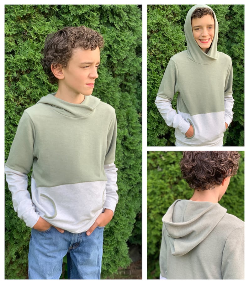 May include: A two-tone green and white long-sleeved hooded sweatshirt with a cowl neck. The sweatshirt has a pocket on the front and contrasting colour on the sleeves.