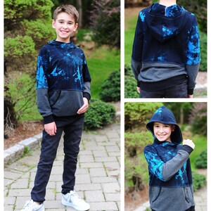 May include: A blue and gray hooded sweatshirt with a tie-dye pattern. The sweatshirt has a kangaroo pocket and a drawstring hood.