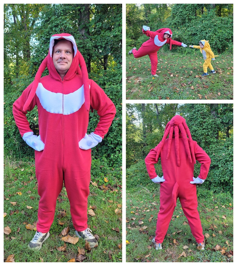May include: Three people wearing red and yellow costumes with long tails. The costumes are inspired by the video game character Knuckles the Echidna. The people are standing in a grassy area with trees in the background.