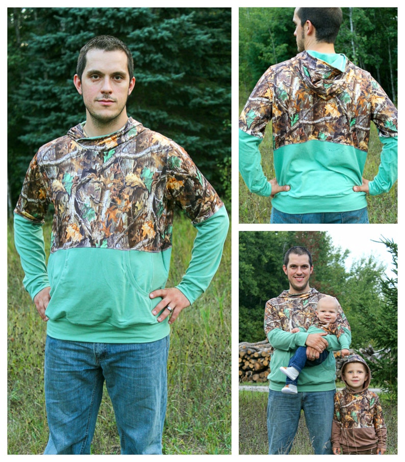 May include: A long-sleeved hooded sweatshirt with a camouflage print on the top half and a solid teal colour on the bottom half. The sweatshirt is shown being worn by three people, including a child.