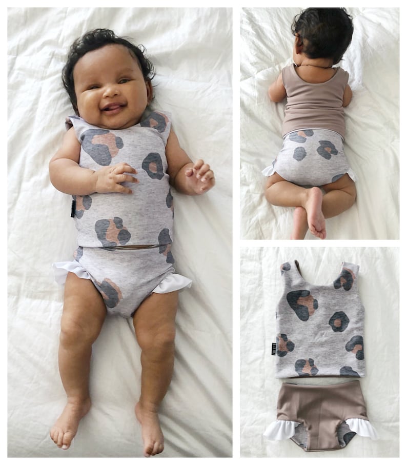May include: A two-piece swimsuit for babies with a grey and brown leopard print. The top is sleeveless and the bottom has a ruffle trim.