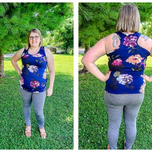 May include: A woman wearing a navy blue tank top with a floral print and gray leggings. The tank top has a racerback style.