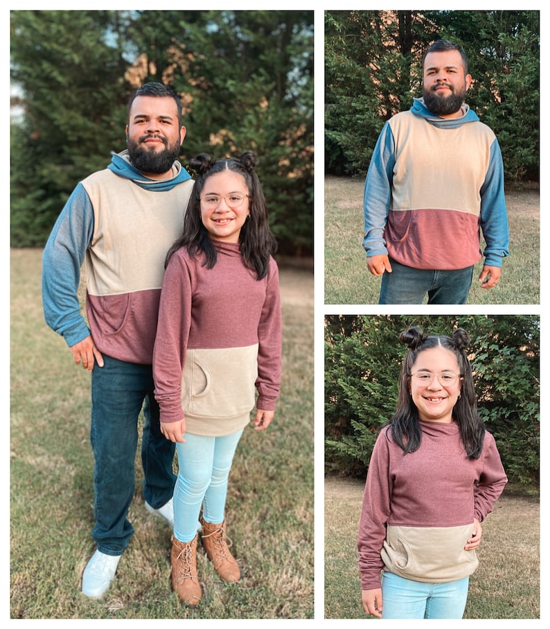 May include: A family of three wearing matching two-toned hoodies. The hoodies are beige and burgundy with a kangaroo pocket on the front. The family are standing in a grassy area with trees in the background.