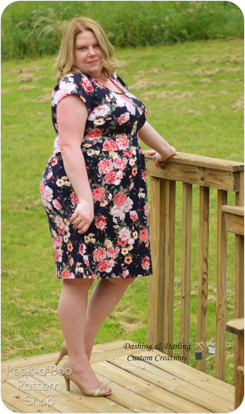 May include: A woman wearing a floral print dress with short sleeves and a scoop neck. She is standing on a wooden deck with a railing. The text "Dashing & Darling Custom Creations" is visible in the lower right corner of the image.