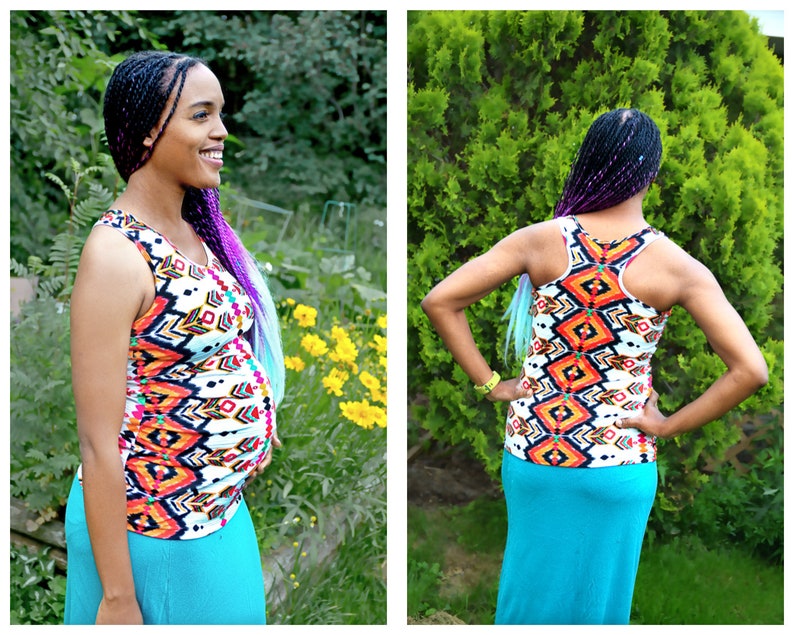 May include: A woman wearing a white tank top with a colorful geometric pattern and a turquoise maxi skirt. She has long purple and blue braids.