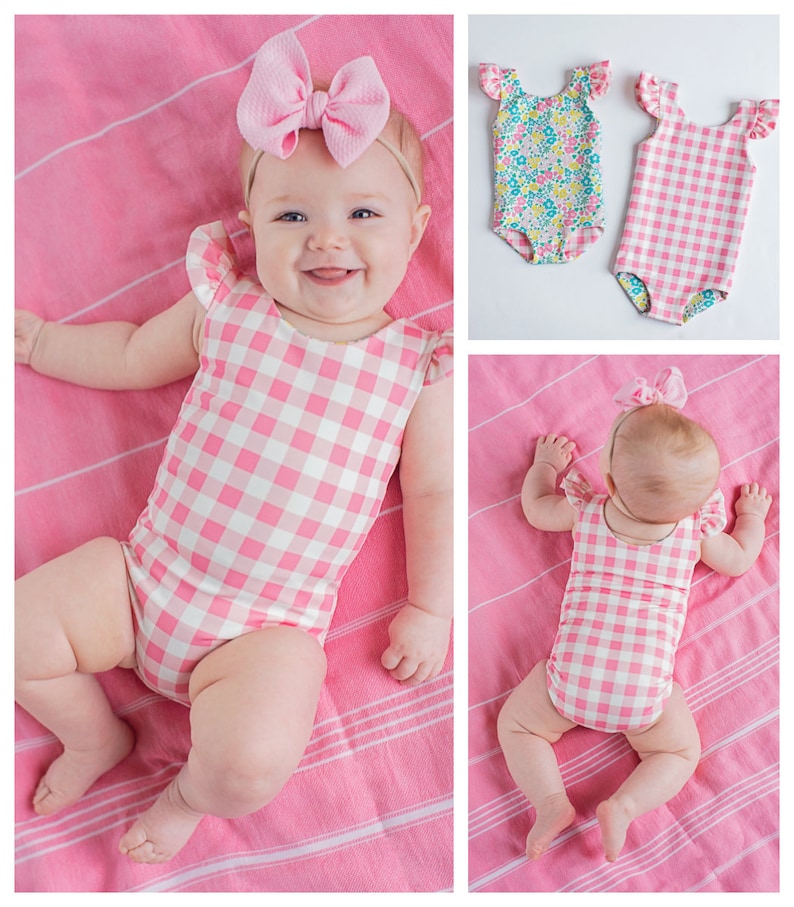 May include: Two baby swimsuits, one with a pink and white gingham pattern and the other with a floral pattern. Both swimsuits have ruffled sleeves.