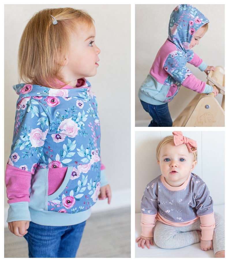 May include: Two toddlers wearing different styles of hooded sweatshirts. The first sweatshirt is blue with a floral print and pink accents. The second sweatshirt is gray with a floral print and pink accents.
