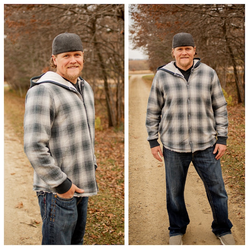 May include: A man wearing a gray and white plaid hooded shirt with a gray baseball cap. He is standing in a wooded area with a dirt path in front of him.