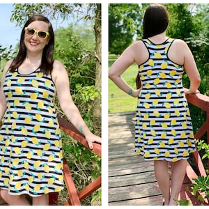 May include: A black and white striped sleeveless dress with a lemon print. The dress has a scoop neck and a flowy skirt.
