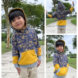May include: A blue and yellow hooded sweatshirt with a geometric pattern. The sweatshirt has a kangaroo pocket and a contrasting yellow panel on the bottom.