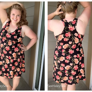 May include: A black sleeveless dress with a floral print in shades of pink, orange, and green. The dress has a scoop neck and a flowy skirt.