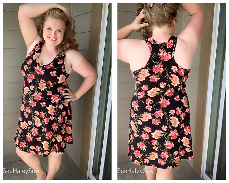 May include: A black sleeveless dress with a floral print in shades of pink, orange, and green. The dress has a scoop neck and a flowy skirt.