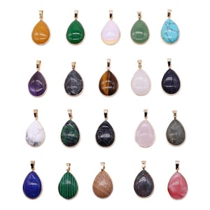 May include: A collection of teardrop-shaped gemstone pendants in various colors, including yellow, green, white, blue, and black. Each pendant has a gold-colored bail for attaching to a chain or cord.