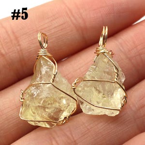 May include: Two raw citrine crystal pendants. Each pendant features a rough, light yellow citrine stone wrapped in gold-colored wire. The wire forms a loop at the top for hanging. The number "#5" is in the top left corner.