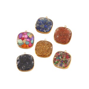 May include: Six square pendants with gold-colored metal frames. Each pendant contains a different arrangement of colorful stones and crystals. The stones are in shades of blue, red, gold, black, and multicolored.