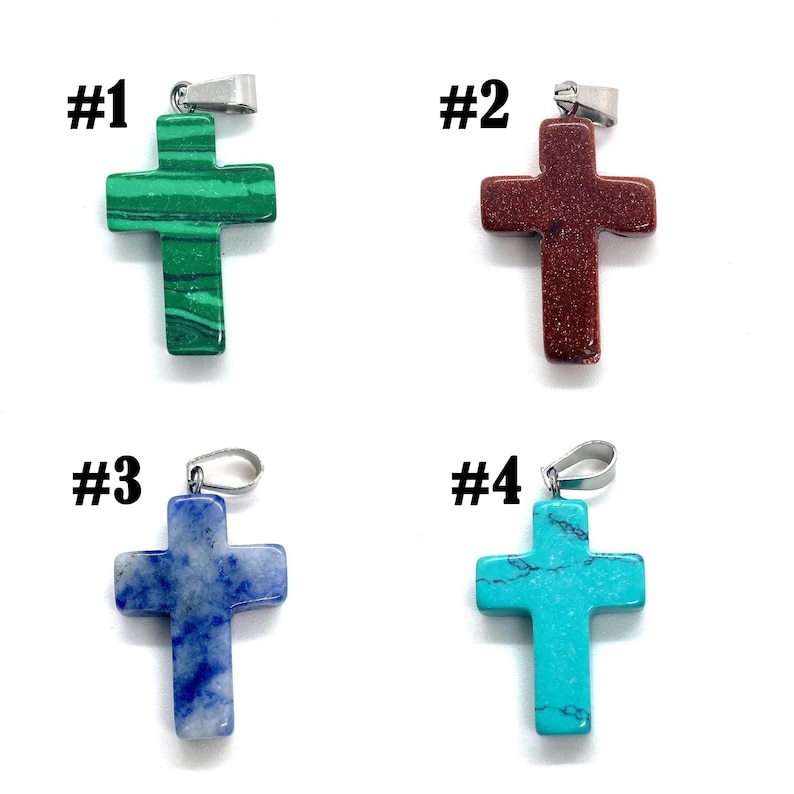 May include: Four gemstone cross pendants with silver-tone bails. The crosses are in shades of green, red-brown, blue, and turquoise. Each pendant is labeled with a number from #1 to #4.