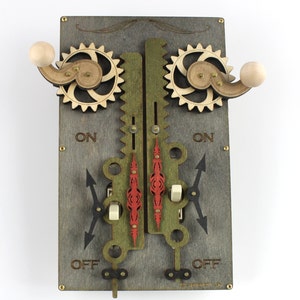 May include: A wooden light switch with a steampunk design. The switch has two knobs, two gears, and two toggle switches. The switch is labeled "ON" and "OFF" on each side.