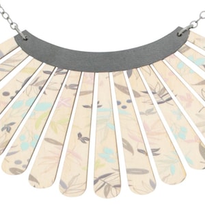 May include: A silver chain necklace with a large, fan-shaped pendant made of wood. The pendant is decorated with a floral pattern in shades of pink, blue, and green.