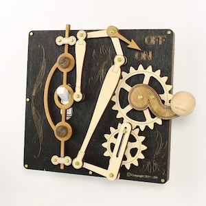 May include: A wooden light switch with a gear mechanism and a wooden knob. The switch is labeled "ON" and "OFF".