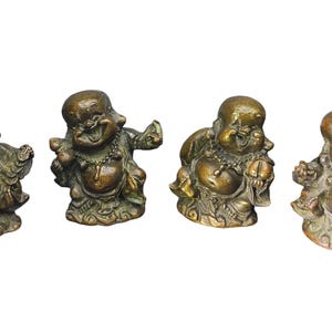 May include: A set of four bronze-toned metal figurines depicting laughing figures with round bellies, each wearing a beaded necklace and seated on a base with swirling patterns. The figures are shown in various poses with arms raised or holding small objects.