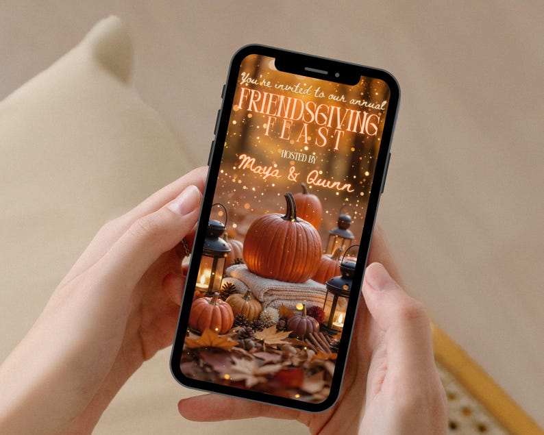 May include: A smartphone displays a Friendsgiving invitation with pumpkins, lanterns, and fall foliage. The text reads "You're invited to our annual FRIENDS GIVING FEAST" hosted by Maya & Quinn.