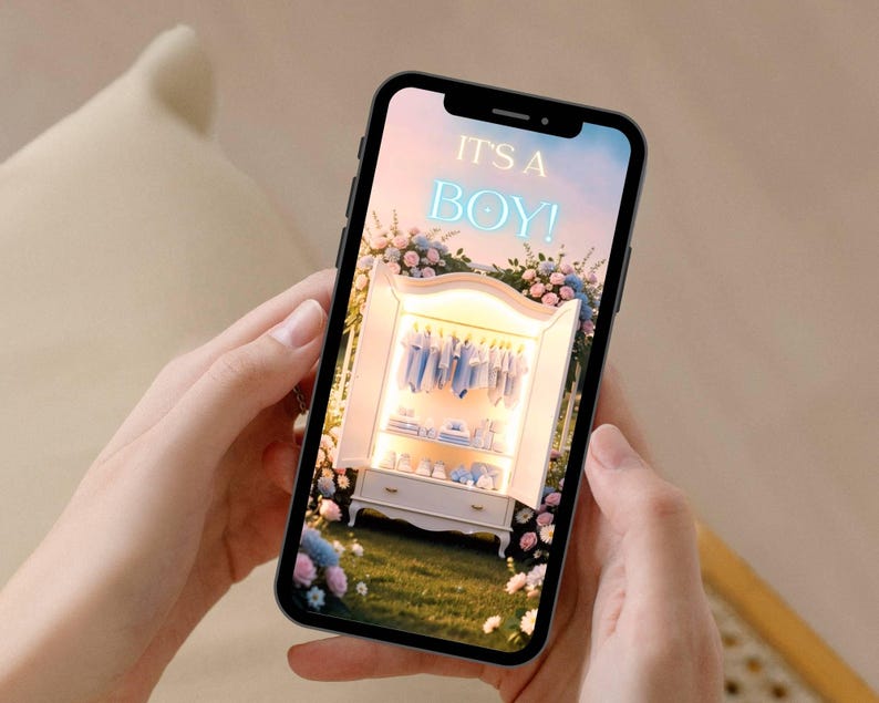 May include: A smartphone displays a digital image with the text "IT'S A BOY!" above a white wardrobe filled with baby clothes. The scene is surrounded by flowers, suggesting a baby shower or announcement.