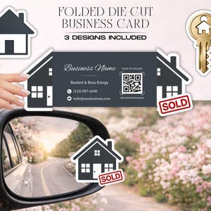 May include: A folded die-cut business card in the shape of a house, with the text "Business Name" and contact information. The card is held up to a car mirror, with a "SOLD" sticker on the house. The image also includes a house-shaped sticker and a gold key.