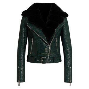May include: A dark green leather jacket with a black fur collar. The jacket features a textured pattern, a zip closure, and a belt at the waist. The sleeves have zips at the cuffs. A fashionable outerwear item.