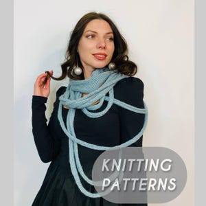 May include: A woman wearing a light blue knitted scarf. The scarf is wrapped around the neck and drapes down the front. The text "KNITTING PATTERNS" is displayed in a gray oval. The woman is wearing a black dress.