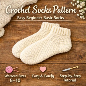 May include: A pair of cream-coloured crocheted socks on a wooden surface. The image includes the text "Crochet Socks Pattern" and "Easy Beginner Basic Socks". Additional text reads "Women's Sizes 5-10", "Cozy & Comfy", and "Step-by-Step Tutorial".