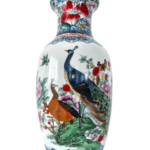 May include: A white ceramic vase with a blue and white floral design and a peacock and pheasant painted on the front.