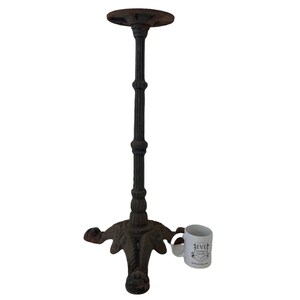 May include: Black cast iron table base with a round top and three legs. The base has a decorative design with a textured finish.