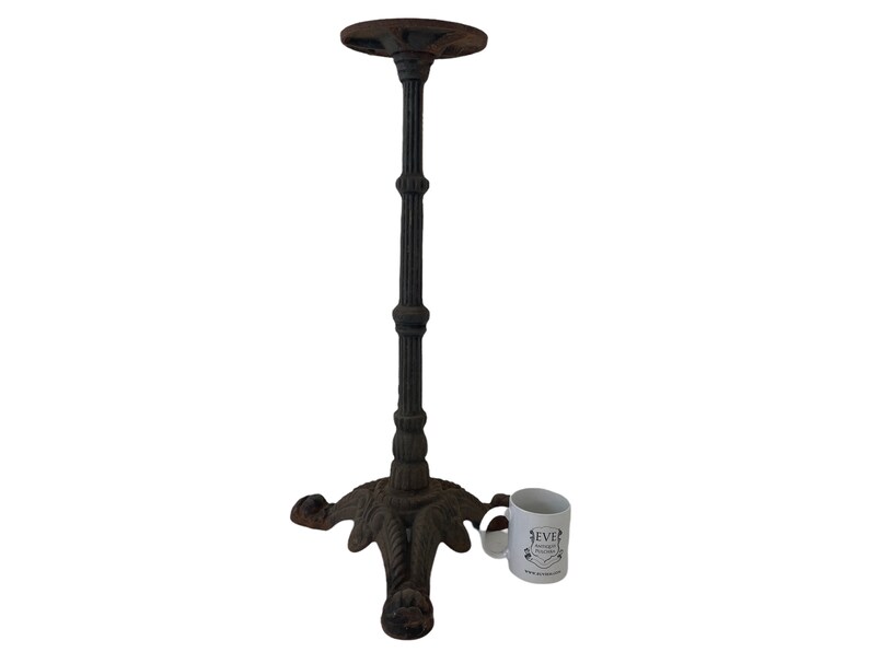 May include: Black cast iron table base with a round top and three legs. The base has a decorative design with a textured finish.