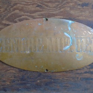 May include: Oval brass plaque with the words "SERVICE NUPELL" embossed on it. The plaque has a worn, aged look.