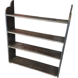 May include: A dark brown wooden wall shelf with four shelves. The shelves have a decorative edge and are angled slightly forward.