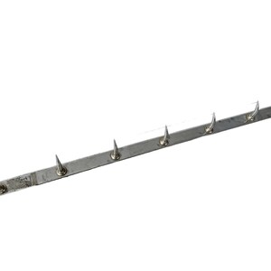 May include: A silver metal strip with sharp points protruding from the top. The strip is about 12 inches long and has 8 points.