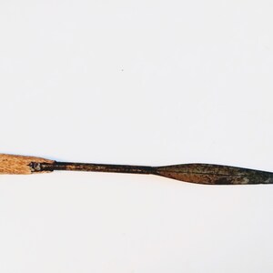 May include: A wooden-handled spear with a rusty metal blade. The spear is about 20 inches long.