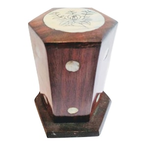 May include: A hexagonal wooden box with a floral design on the top and white pearl accents around the sides. The box is made of dark wood and has a polished finish.
