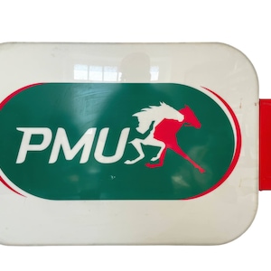 May include: A white rectangular sign with a green oval containing the text "PMU" and a red horse running to the right. The sign is attached to a red metal bracket.