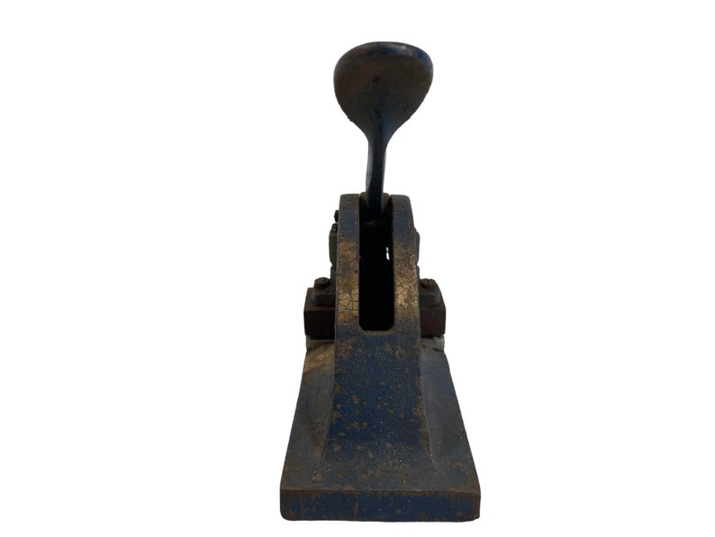 May include: A vintage blue and gold metal hand stamp with a lever.